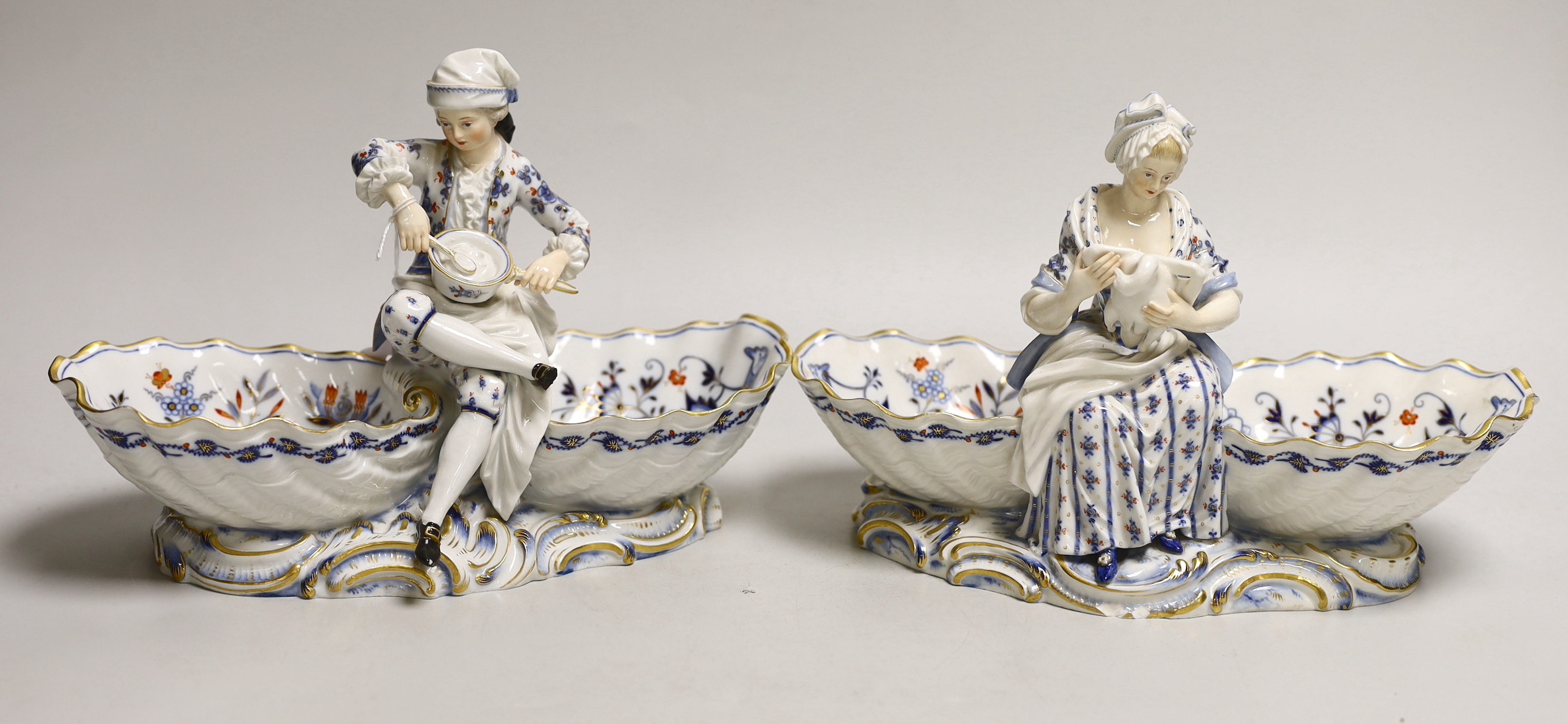 A pair of late 19th century Meissen figural sweetmeat dishes, 24.5cm wide